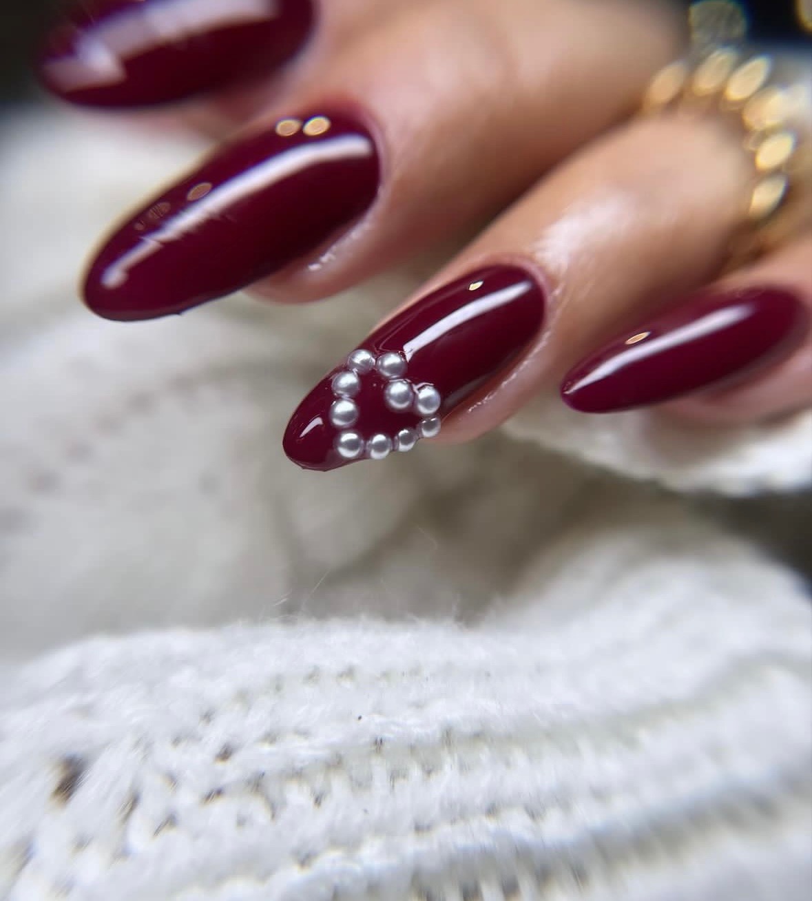 Burgundy nails with pearl heart accent